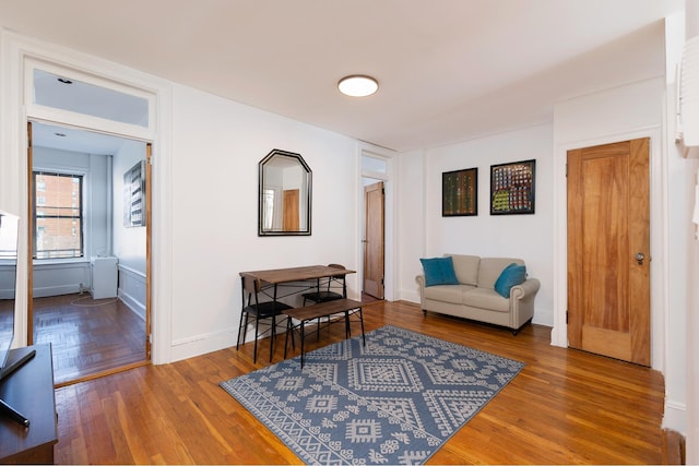 living area with wood finished floors and baseboards