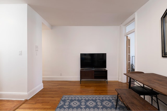 living area with wood finished floors and baseboards