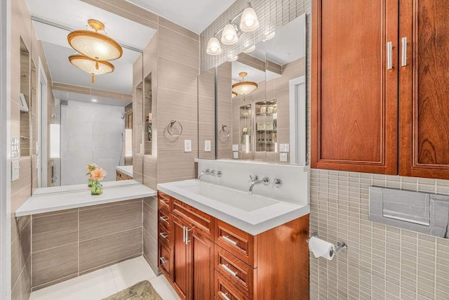 1725 York Ave Unit 26E, New York City, NY 10128 - bathroom featuring tile walls, vanity, and tile patterned flooring