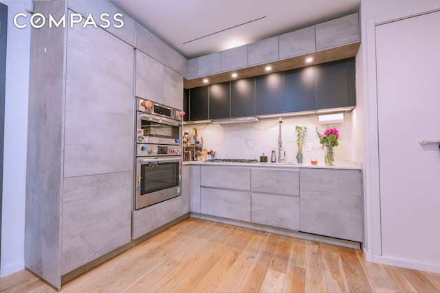 548 Lafayette Ave Unit 1A, New York City, NY 11205 - kitchen with stainless steel appliances, light wood finished floors, modern cabinets, light countertops, and a sink
