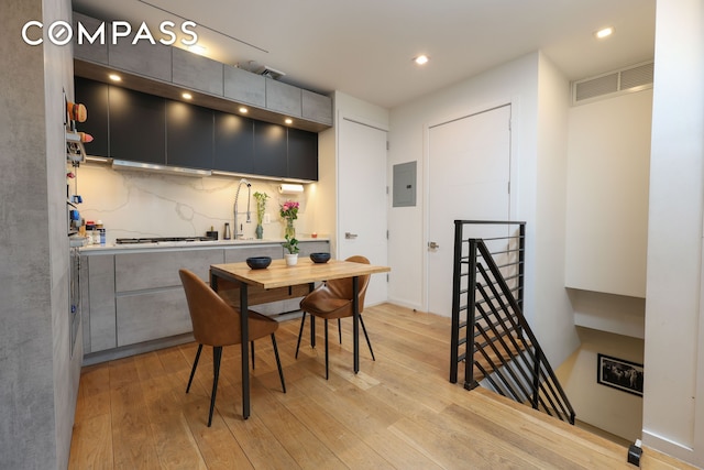 dining space with electric panel, visible vents, light wood-style flooring, and recessed lighting