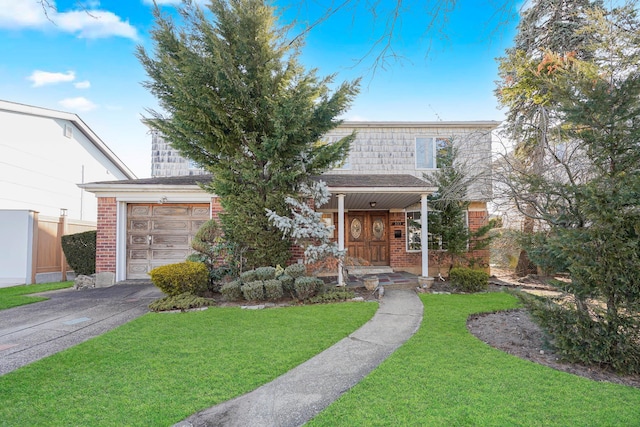 view of front of home featuring a front lawn, a garage, brick siding, and driveway