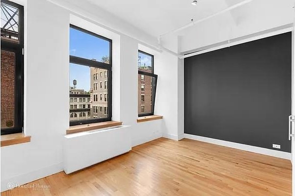 empty room with wood finished floors and baseboards