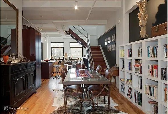 dining room featuring stairway and light wood-style flooring