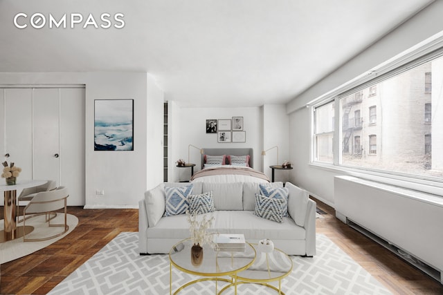 bedroom featuring parquet floors and radiator heating unit