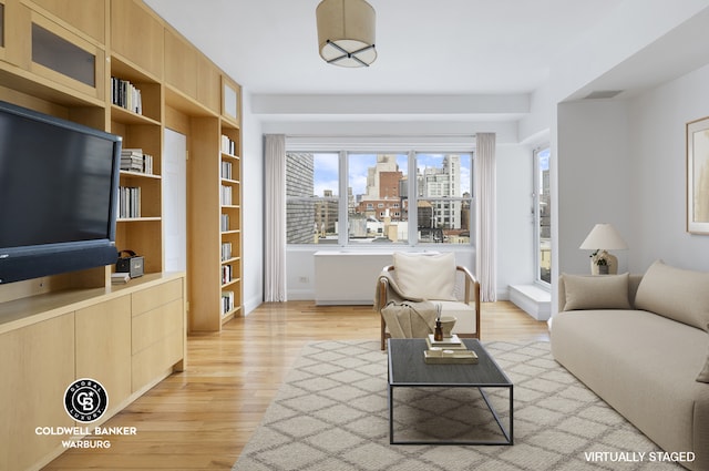 living area featuring a view of city, visible vents, and light wood finished floors