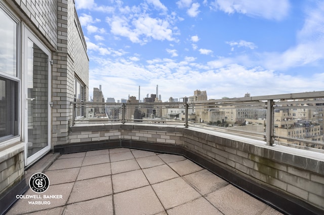 view of patio featuring a city view and a balcony