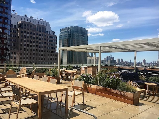 view of patio / terrace with a view of city, outdoor dining area, and a pergola