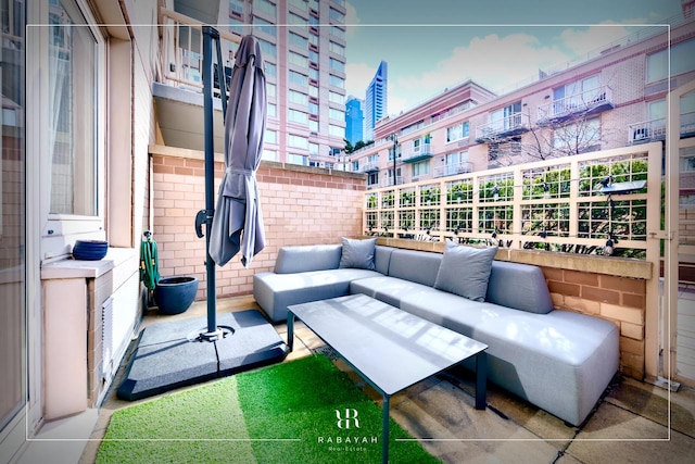 view of patio with an outdoor living space and a view of city