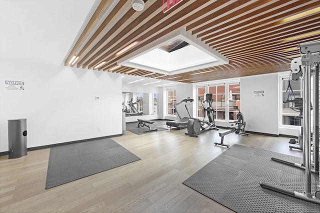 exercise room featuring wood finished floors and baseboards