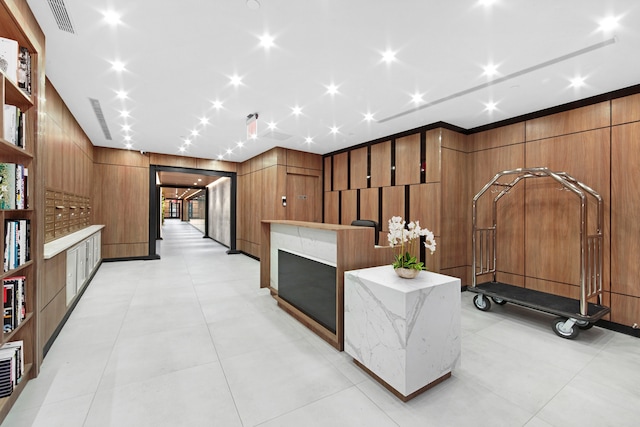 reception area with wooden walls and a fireplace
