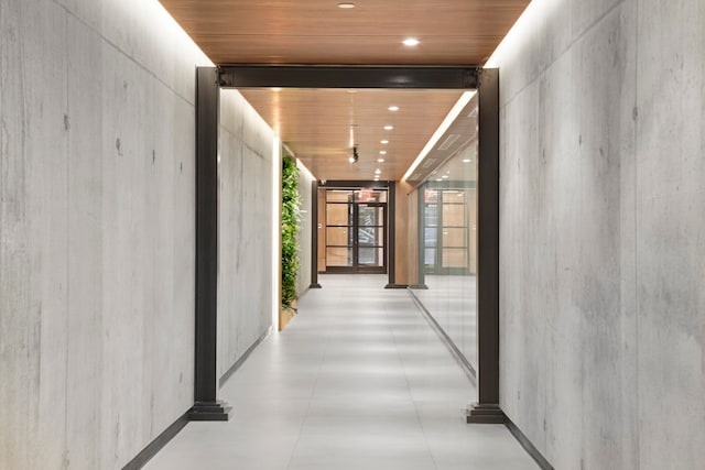 corridor with recessed lighting, floor to ceiling windows, and wooden ceiling