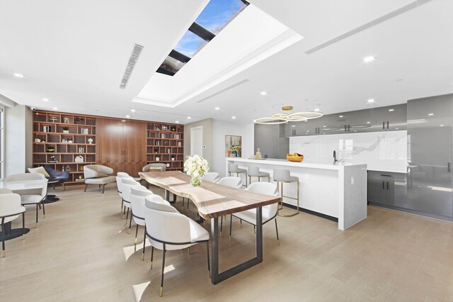 37-26 32nd St Unit 2-L, New York City, NY 11101 - dining area with built in features, light wood finished floors, and recessed lighting