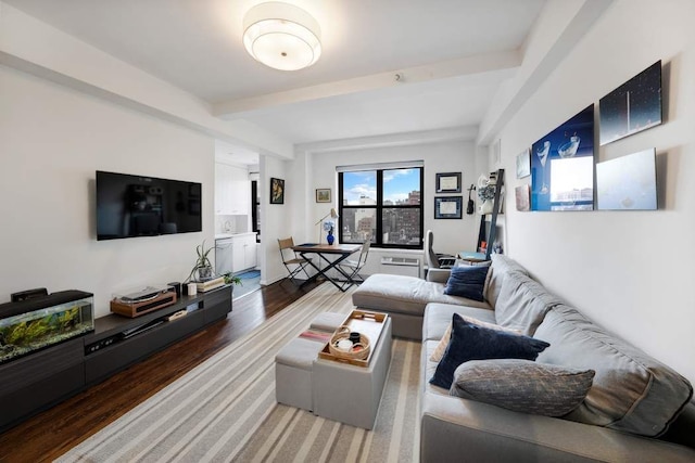 living area with beamed ceiling and wood finished floors