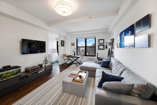 living area with wood finished floors and beam ceiling