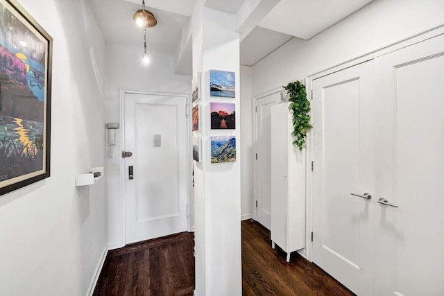 hallway with dark wood-style floors and baseboards