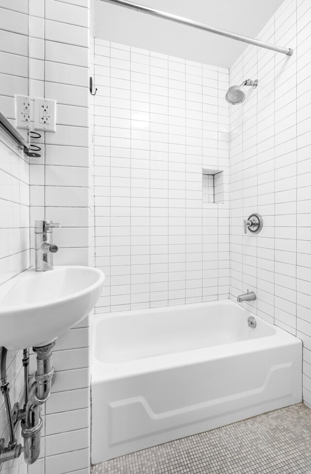 full bath featuring tile walls, shower / bathing tub combination, and tile patterned floors