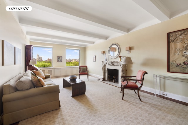 living area with beam ceiling, a fireplace, visible vents, and baseboards