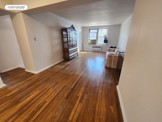 interior space featuring radiator, cooling unit, baseboards, visible vents, and dark wood finished floors