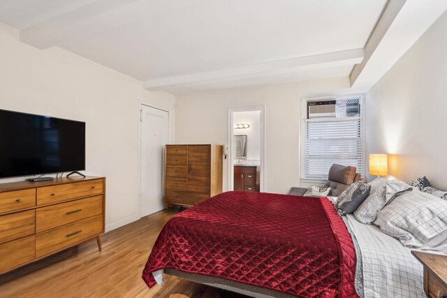 333 E 43rd St Unit 110/111, New York City, NY 10017 - bedroom with light wood-style floors and connected bathroom