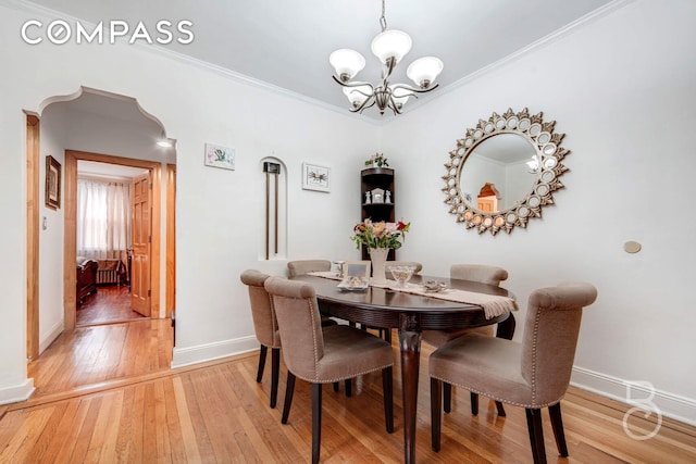 46-10 28th Ave, New York City, NY 11103 - dining area featuring light wood-style flooring, baseboards, an inviting chandelier, and ornamental molding