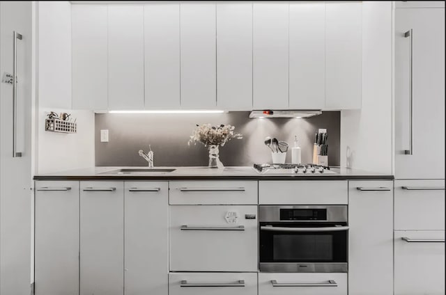 kitchen with modern cabinets, white cabinets, gas stovetop, and oven