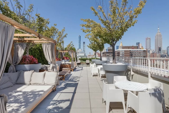 view of patio / terrace with a view of city, outdoor lounge area, and a pergola