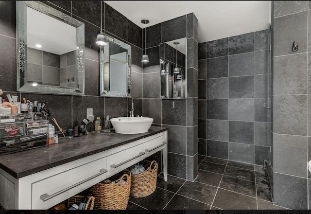 full bathroom featuring backsplash, tile walls, and vanity