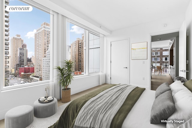 501 3rd Ave Unit 12E, New York City, NY 10016 - bedroom featuring a city view and wood finished floors