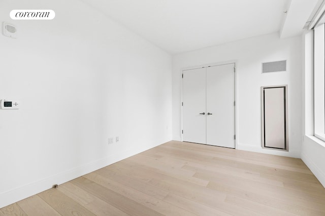 501 3rd Ave Unit 12E, New York City, NY 10016 - unfurnished bedroom featuring light wood finished floors and a closet