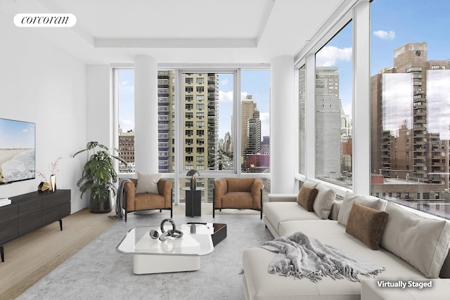 501 3rd Ave Unit 12E, New York City, NY 10016 - living area featuring a city view, wood finished floors, and a raised ceiling