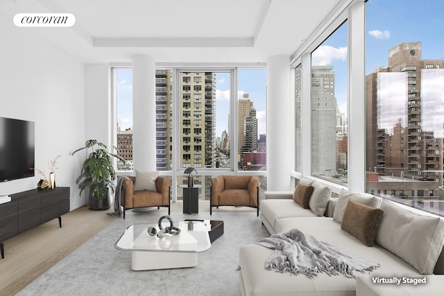 501 3rd Ave Unit 12E, New York City, NY 10016 - living room with a view of city, wood finished floors, and a tray ceiling