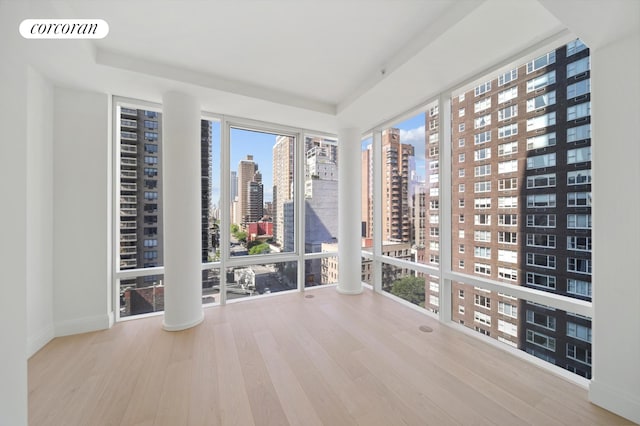 unfurnished sunroom with visible vents and a view of city