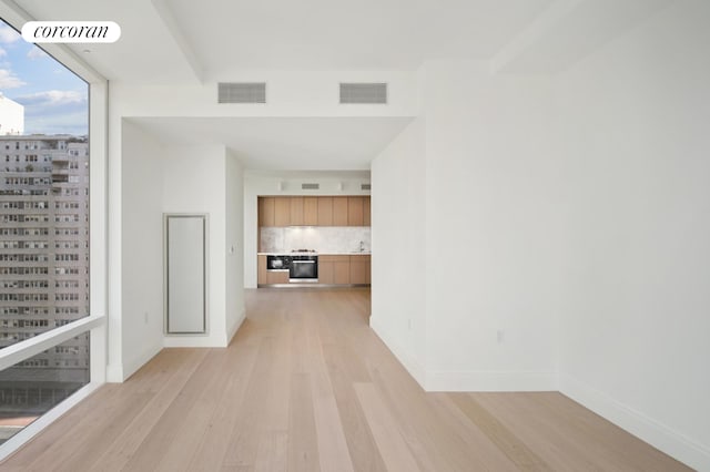 interior space with visible vents, baseboards, and light wood-style floors