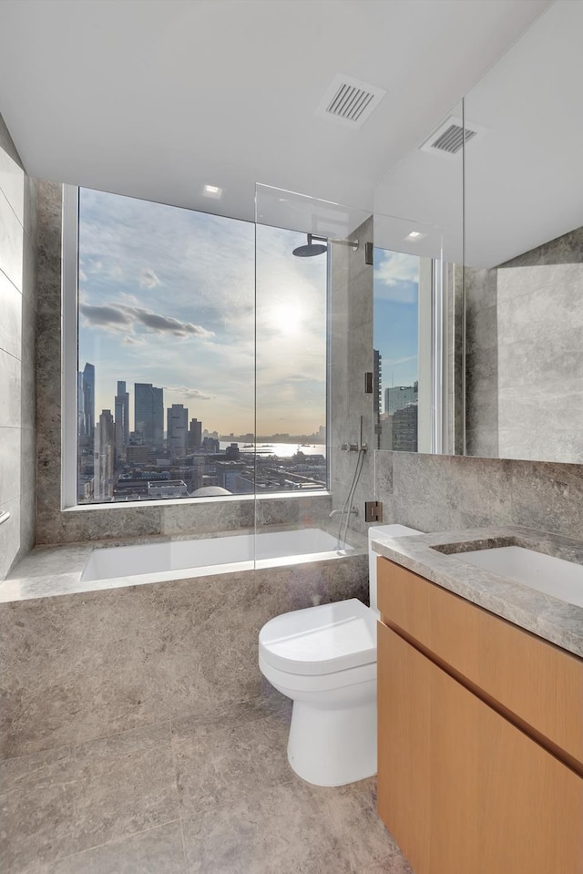 bathroom with visible vents, toilet, a city view, tile walls, and vanity