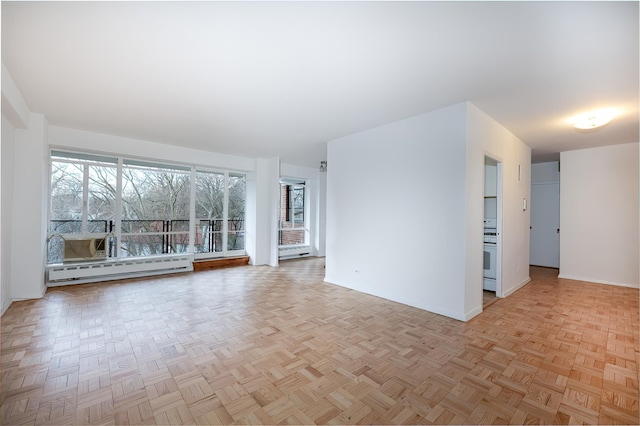 unfurnished living room featuring baseboard heating