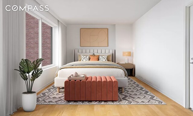 bedroom featuring baseboards and wood finished floors