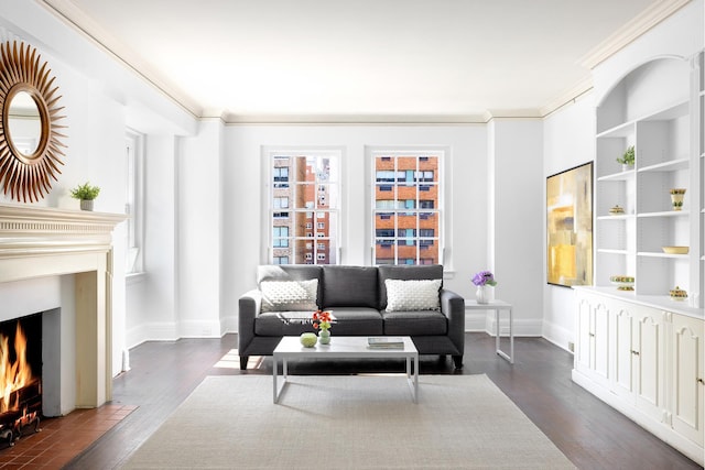 living area featuring dark wood-style floors, a fireplace with flush hearth, crown molding, and baseboards