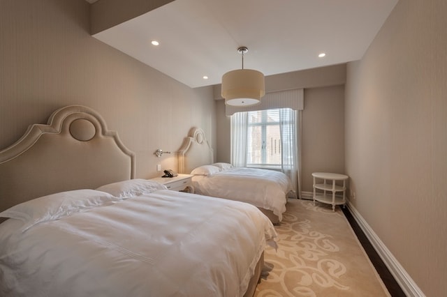 bedroom with recessed lighting, baseboards, and light carpet