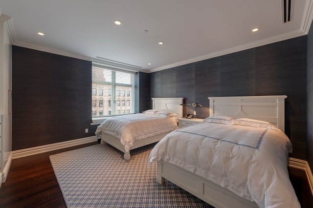 bedroom featuring recessed lighting, wood finished floors, baseboards, and ornamental molding