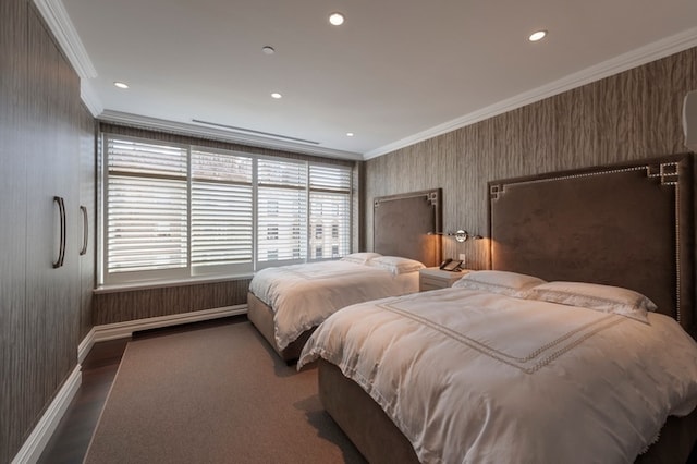 bedroom with wood finished floors, baseboards, wallpapered walls, recessed lighting, and crown molding