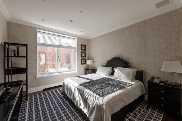 bedroom with visible vents, dark wood-type flooring, ornamental molding, wallpapered walls, and baseboards