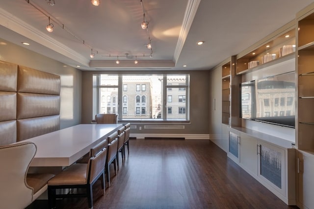 unfurnished dining area with dark wood-style floors, baseboards, a tray ceiling, recessed lighting, and crown molding