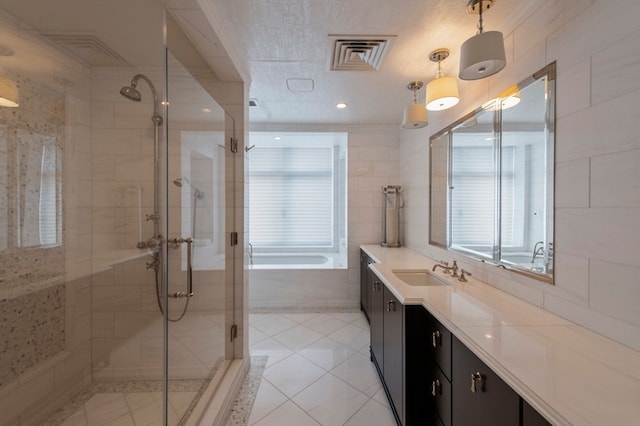 bathroom featuring vanity, visible vents, a stall shower, tile walls, and a bath