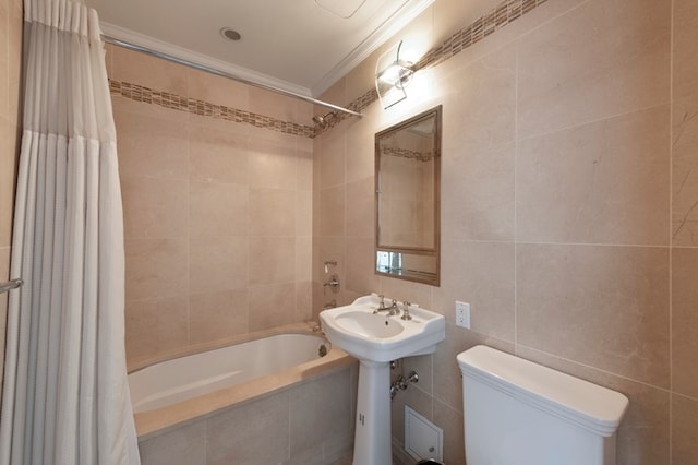 full bath featuring tile walls, ornamental molding, toilet, and tiled shower / bath combo