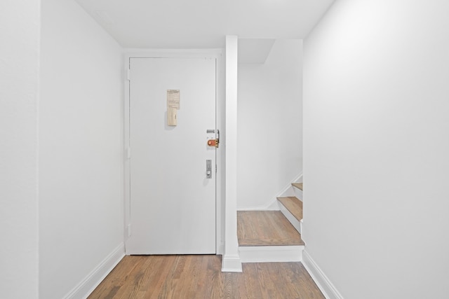 interior space featuring stairway, baseboards, and wood finished floors