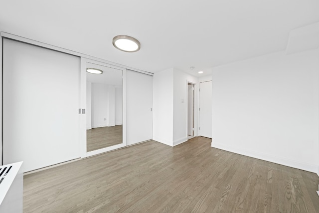 empty room with wood finished floors and baseboards