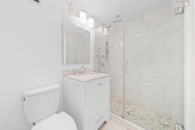 full bath featuring a shower stall, toilet, and vanity