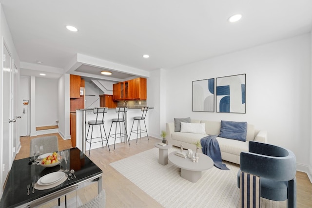 living area with recessed lighting and light wood-style floors