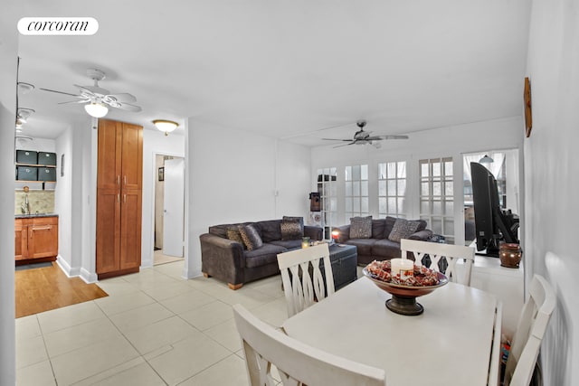 dining space with light tile patterned floors, visible vents, and ceiling fan